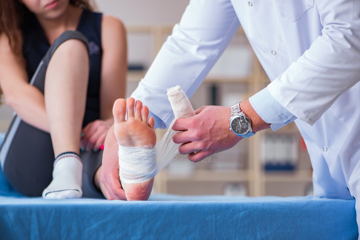 Woman getting wound care on foot
