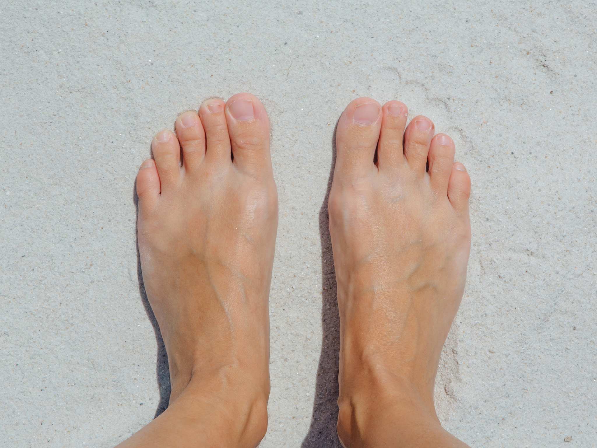 Feet on the white sand.