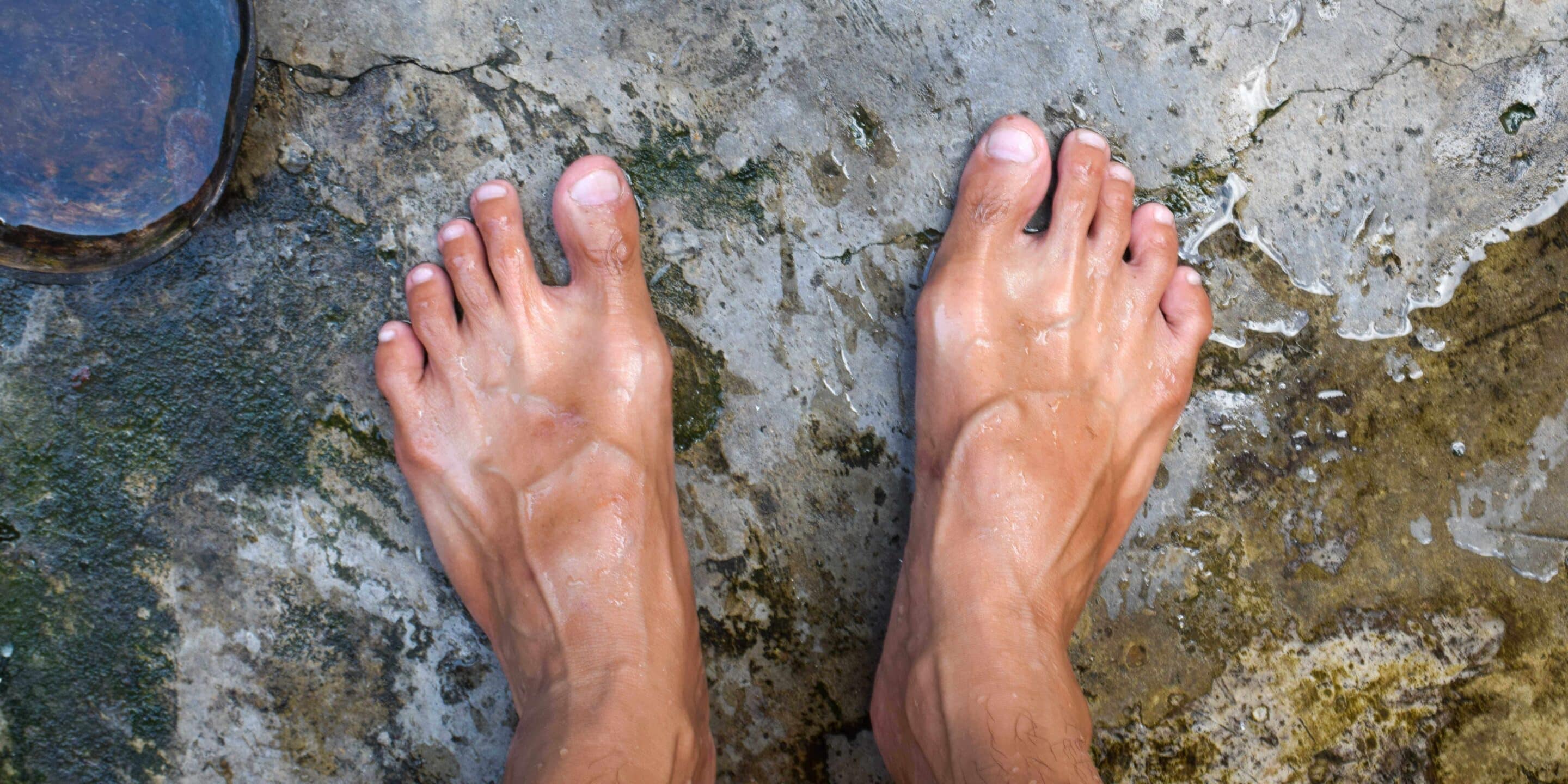 photo of a man's feet wet in water